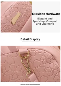 Detailed close-up of light gold metal hooks and embossed floral pattern on pink PU leather