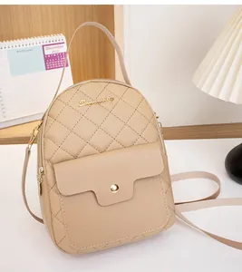 Close-up of beige quilted leather backpack with gold embroidery and metal buckle detail