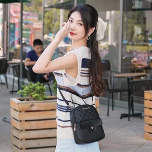 Mini black quilted PU leather backpack for women featuring elegant gold metal hardware