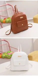 Detail view of mini backpacks with clover embossing and metallic hardware accents