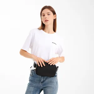 Minimalist black nylon waist bag for women shown with model in white tee and denim