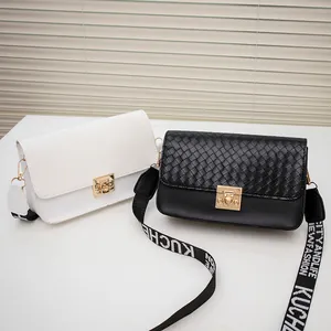 Mini woven flap crossbody bags in black and white with decorative logo straps