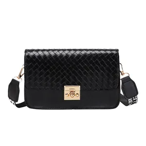 Black woven leather crossbody bag with golden turn-lock and stylish wide patterned strap