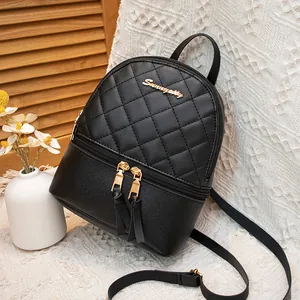 Black quilted mini backpack for women with gold hardware and tassel detail in a cozy setting