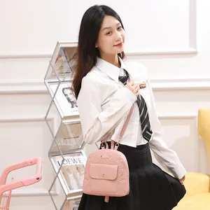 Pink mini embossed floral backpack for women with convertible crossbody strap and metal detail