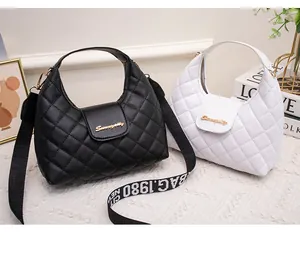 Quilted crossbody bags in black and white with golden logo and wide fabric straps
