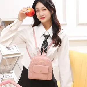 Pink mini backpack for women featuring cute flower and heart embossing on PU leather surface