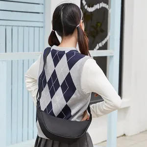 Black crescent crossbody bag in matte washed fabric shown on model for daily casual wear