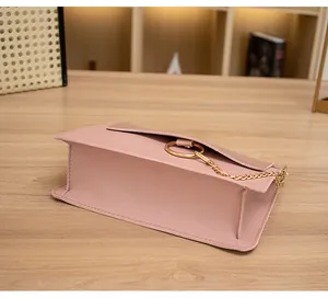 Detail of pink PU leather flap bag with gold metal ring and fine chain strap
