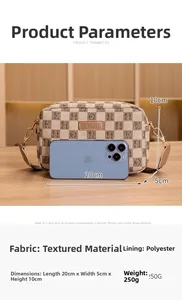 Detailed size view of khaki plaid crossbody bag with H-pattern and phone for scale