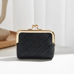 Vintage woven mini coin purse in black with gold kiss-lock metal frame and textured surface