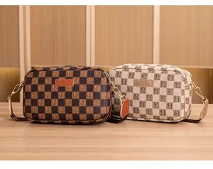 Detail of checkered patterns and embossed logos on brown and beige crossbody bags