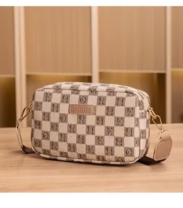 Detail of HORHE plaid camera bag with golden hardware and textured fabric strap