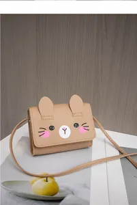 Detail of a brown leather mini crossbody bag for kids with cute rabbit ears and animal face