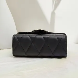 Classic black quilted crossbody bag with diamond patterns and metallic lock detail
