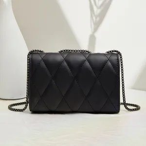Elegant black quilted crossbody bag with diamond stitching and metal chain strap