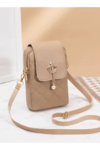 Detail of quilted crossbody phone bag with gold crown charm and pearl pendant detail