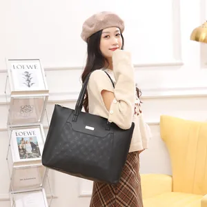 Black faux leather tote bag with quilted diamond pattern and metallic logo for women