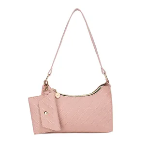 Pink embossed underarm shoulder bag with matching mini pouch and gold hardware details