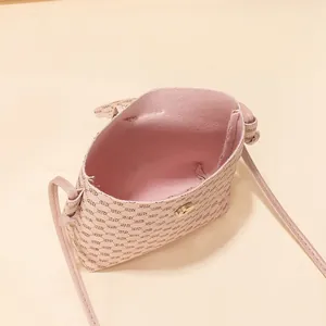 Nude pink mini crossbody phone bag with monogram print and magnetic closure for women
