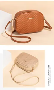 Detail of wavy quilted shoulder bags in brown and beige featuring golden metal logo