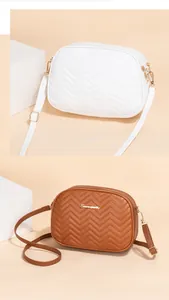 Detailed view of quilted chevron crossbody bags with golden zippers and adjustable straps