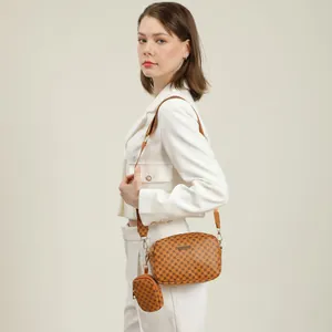 Brown monogram crossbody camera bag with small round coin purse on wide strap
