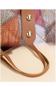 Detail of high-polish metal hardware and quilted stitching on women's tote bag