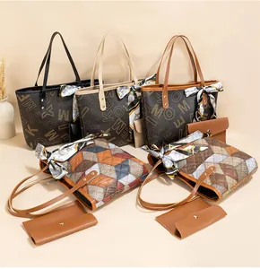 Detail of elegant tote bag set with monogram print, quilting, and floral scarf