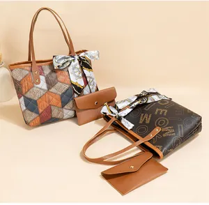 Close-up of cube pattern tote bag with letter prints and decorative silk scarf detail