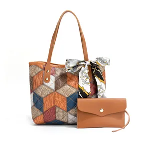 Detail view of cube geometric embroidered tote bag with matching envelope clutch and silk scarf