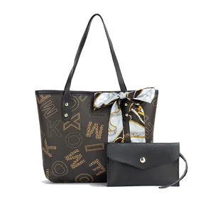 Detail of printed tote bag with matching black pouch and silk scarf accessory