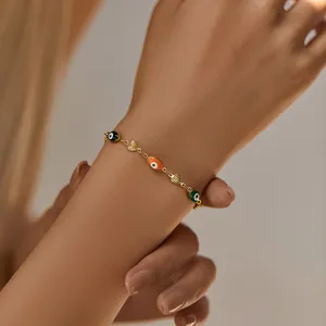 Close-up of handmade 18K gold-plated evil eye beaded bracelet on a model's wrist
