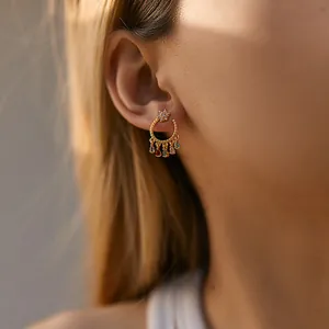 Detail of 18K gold plated brass earrings featuring colorful star and water-drop zircons