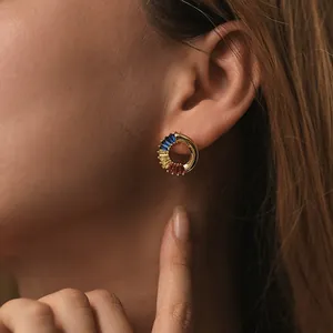 Close-up of C-shaped 18K gold-plated earrings set with colorful rectangular gemstones