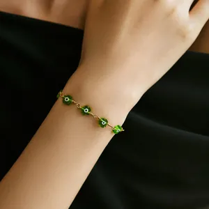 Handmade evil eye flower bracelet in green with 18K gold plated wire wrapped beads