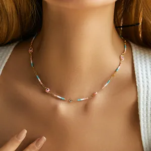 Bohemian beaded necklace with evil eye pendants and 18K gold plated accents on model