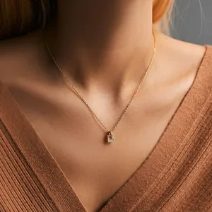 Close-up of a 18K gold plated Christmas tree necklace with zircons on a model