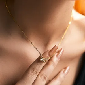 Close-up of 18K gold plated butterfly necklace with zircon stones on a model