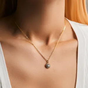 Close-up of 18K gold plated halo necklace with sparkling round zircon pendant on neck