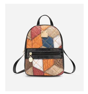 Detail of colorful patchwork backpack with rhombic embroidery and gold tone hardware