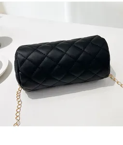 Top-down view of a black quilted cylinder bag with an elegant golden chain strap