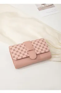 Detailed macro view of a pink PU leather mini wallet with chic clover-patterned strap closure