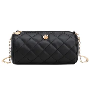 Elegant black quilted cylinder bag with gold flower detail and chain strap for women