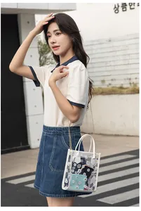 Detailed view of clear PVC crossbody bag with daisy prints and gold chain strap