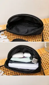 Internal view of the black crossbody bag showing spacious partition storage capacity