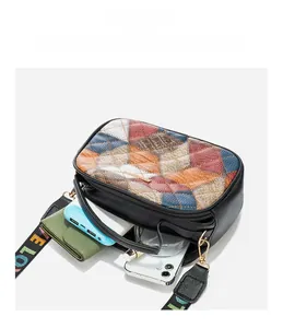 Detail showing the large capacity of a multi-color quilted crossbody bag with a strap