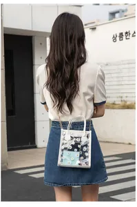 Detailed view of transparent PVC crossbody bag with daisy print and golden chain strap