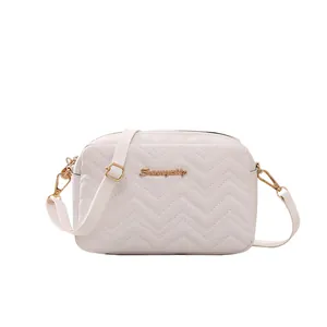 Beige quilted crossbody bag with V-shaped wave embroidery and gold metal hardware