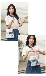 Detailed view of clear PVC tote bag with white daisy print and faux leather handle
